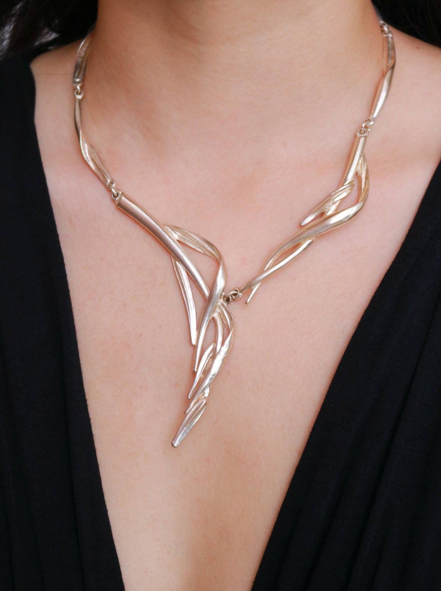 Signed Dolce Vita asymmetric statement necklace with an artistic cascading sculptural design.