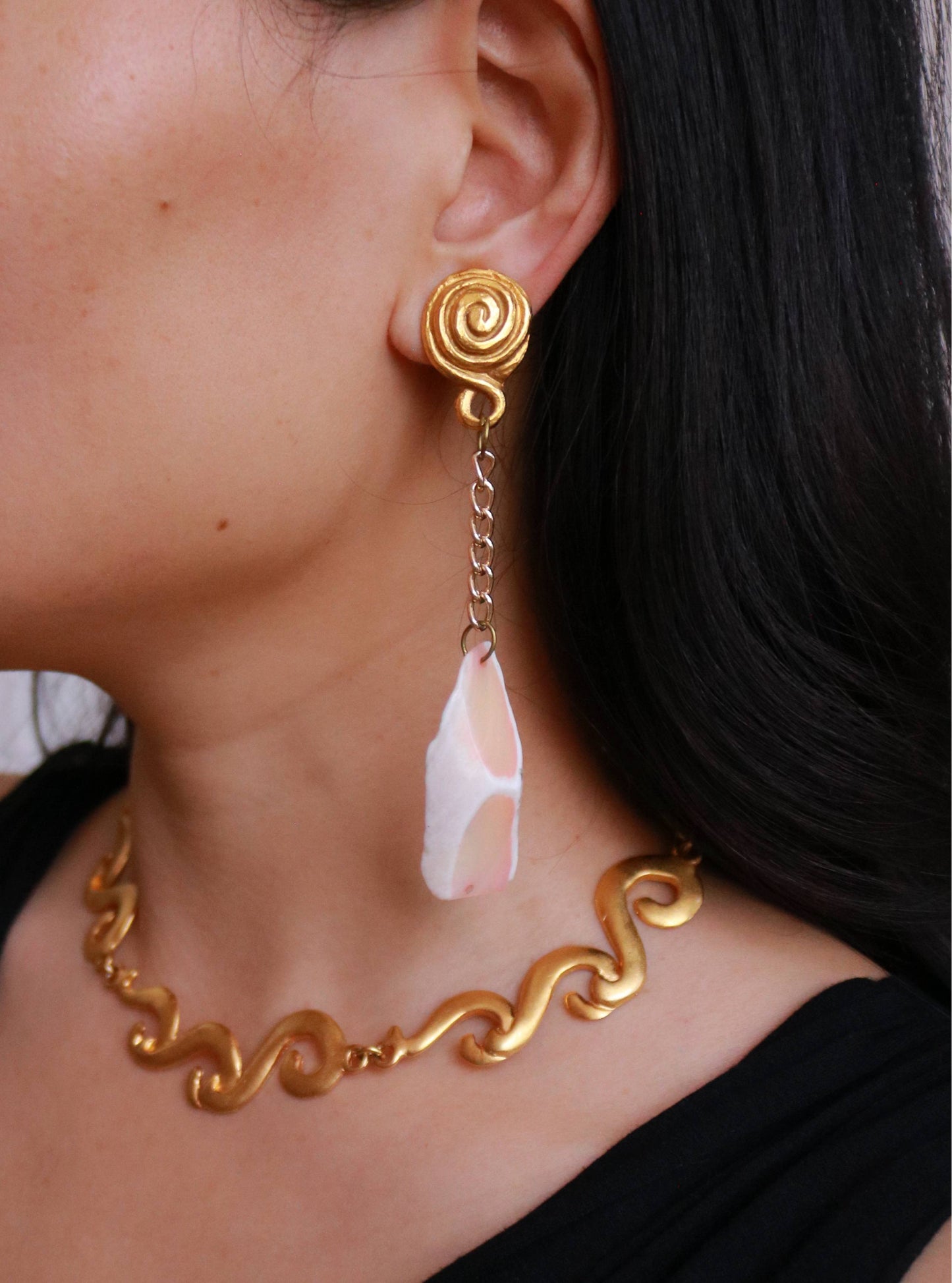 Vintage natural shell long clip-on earrings worn on model, showcasing their elegant movement and statement silhouette.