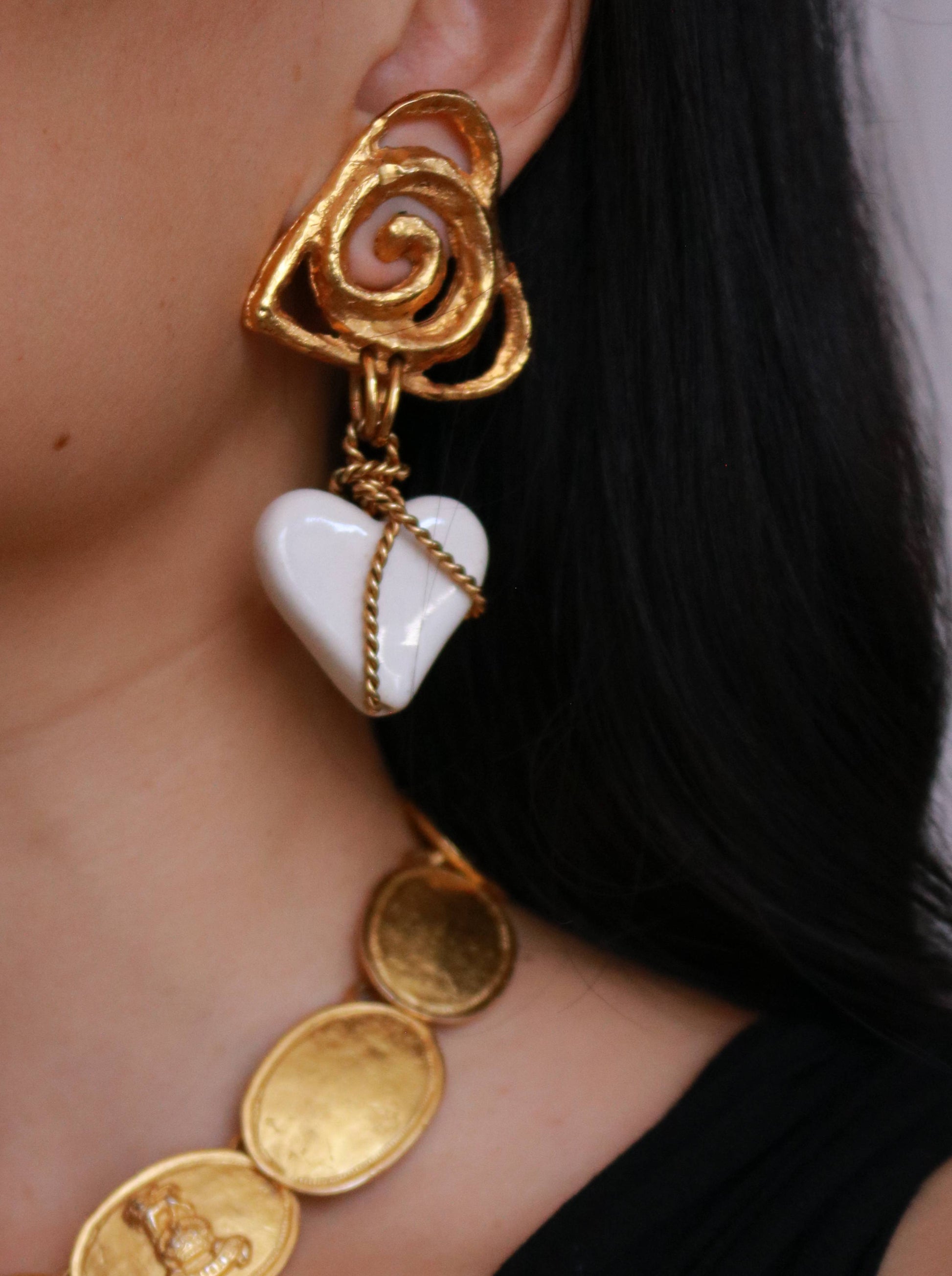 Vintage Carole Saint Germès 24K gold plated heart clip-on earrings worn on model, showcasing their artistic French design.