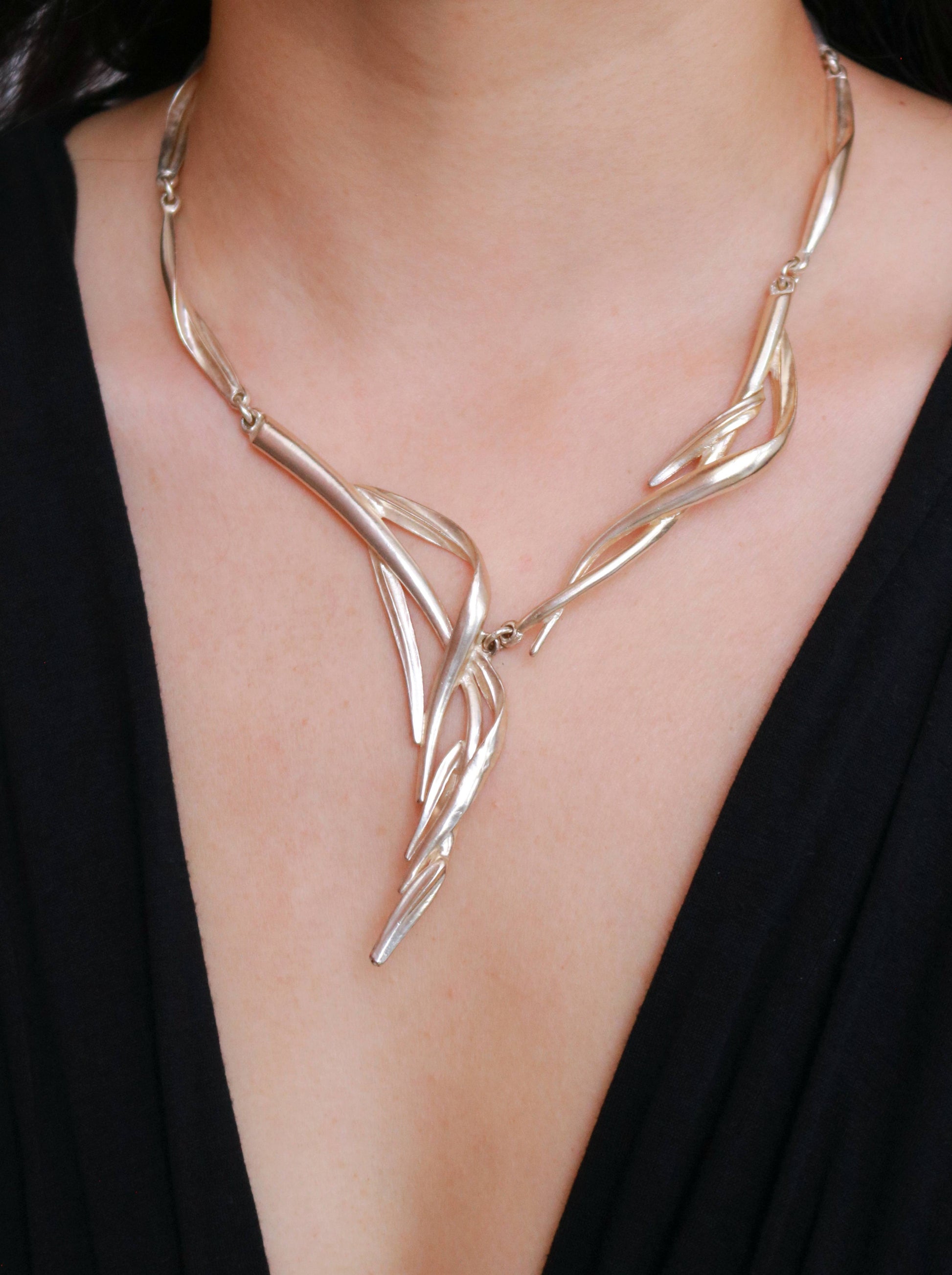 Signed Dolce Vita asymmetric statement necklace with an artistic cascading sculptural design.