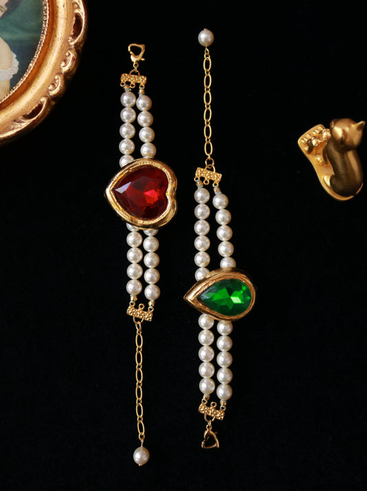 Vintage YSL Style faux pearl bracelets from the 1970s featuring red and green faceted glass stones with gold-tone detailing.