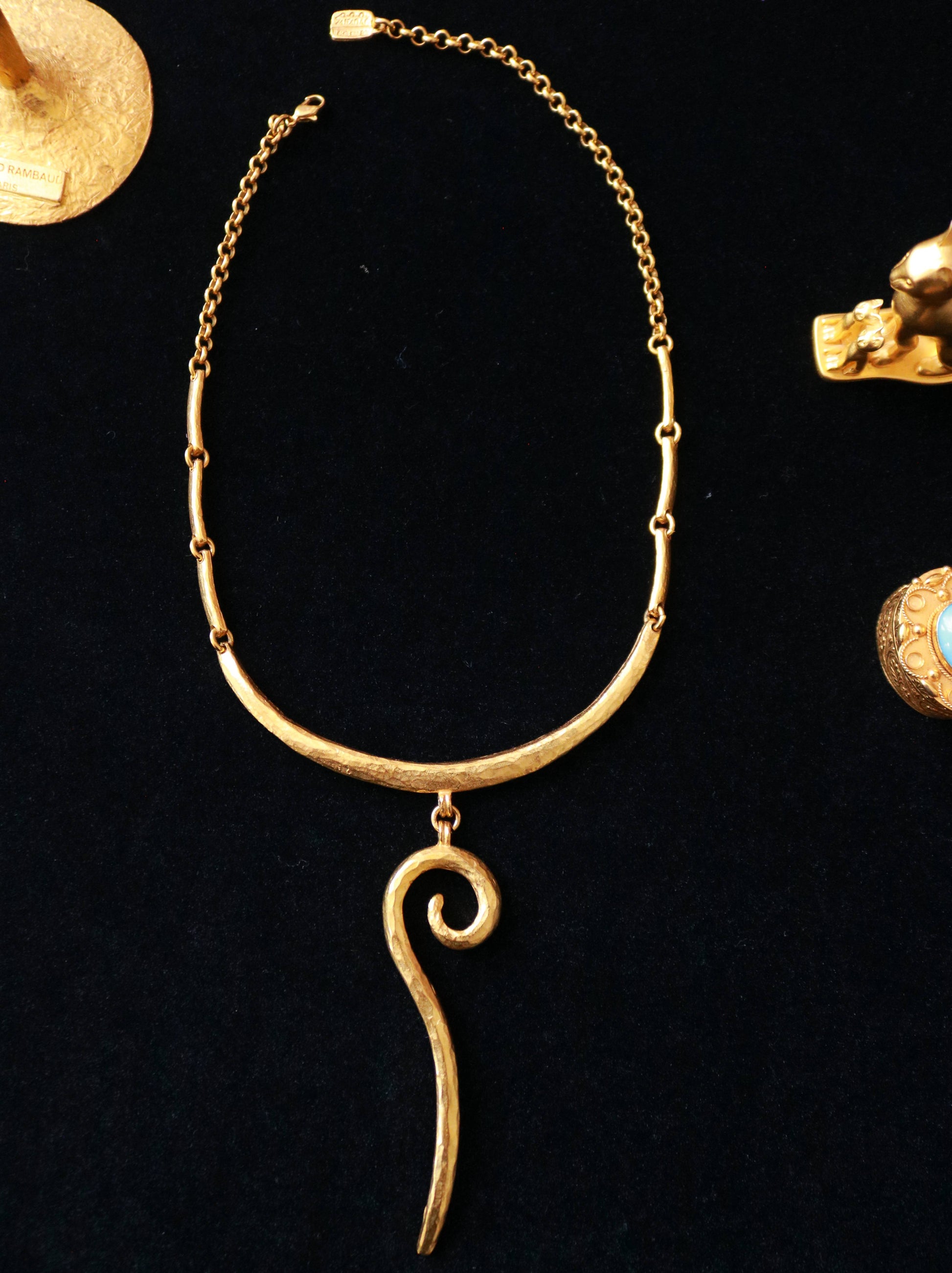 Vintage Il Était Une Fois gold-tone sculptural drop collar necklace with hammered texture and abstract spiral pendant.