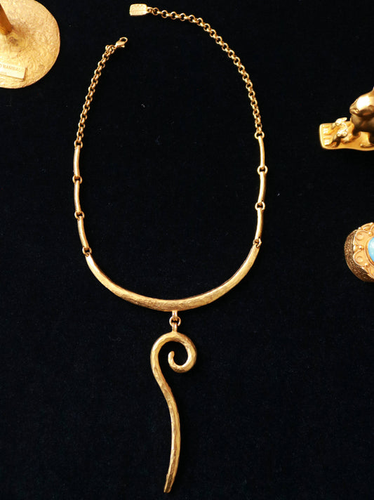 Vintage Il Était Une Fois gold-tone sculptural drop collar necklace with hammered texture and abstract spiral pendant.