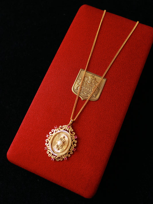 Vintage FIX gold plated ornate pendant necklace with faux pearl and red crystal accents.