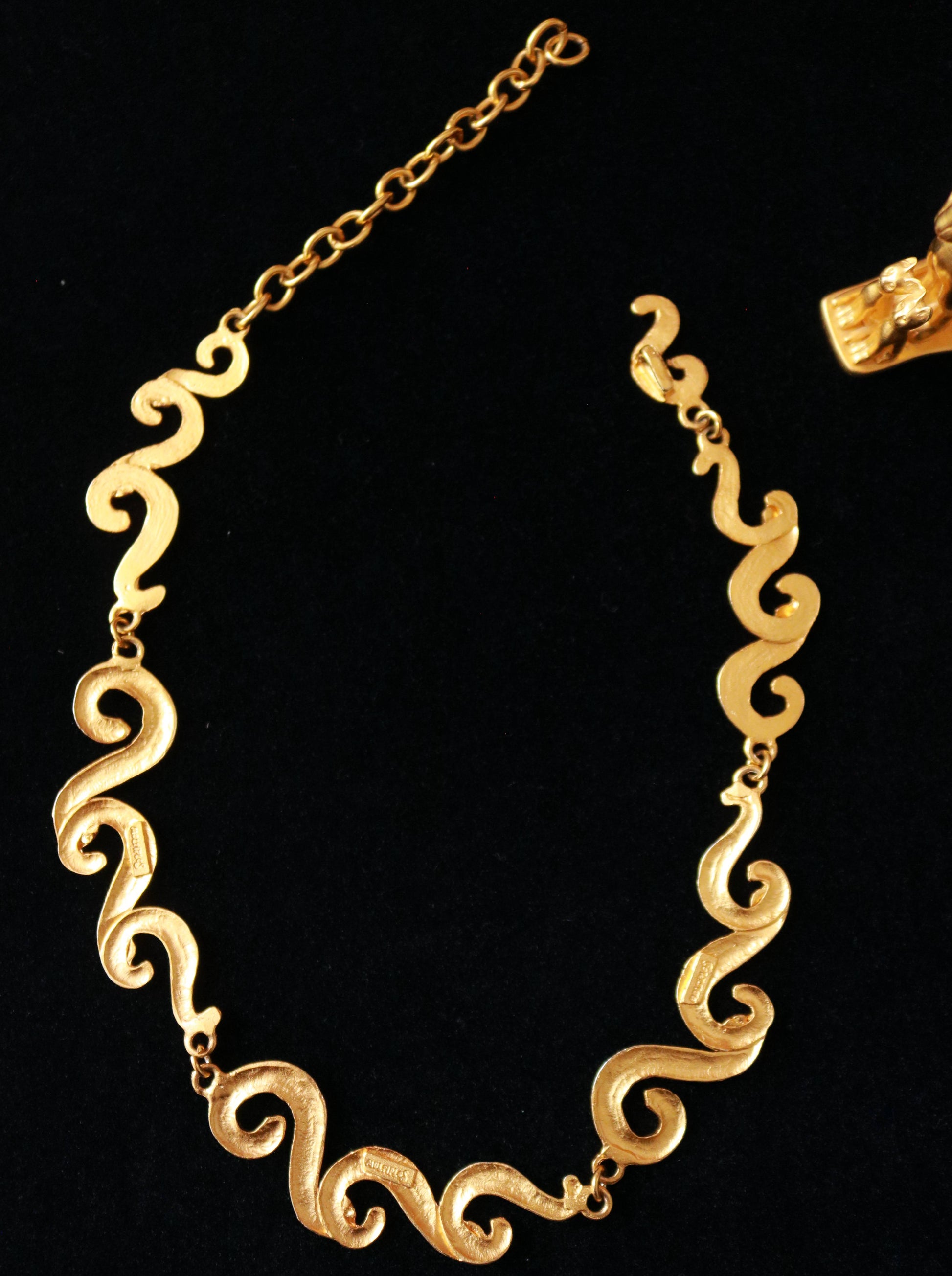 Close-up of signed vintage Multiples necklace with elegant flowing gold-tone links and sculptural craftsmanship.