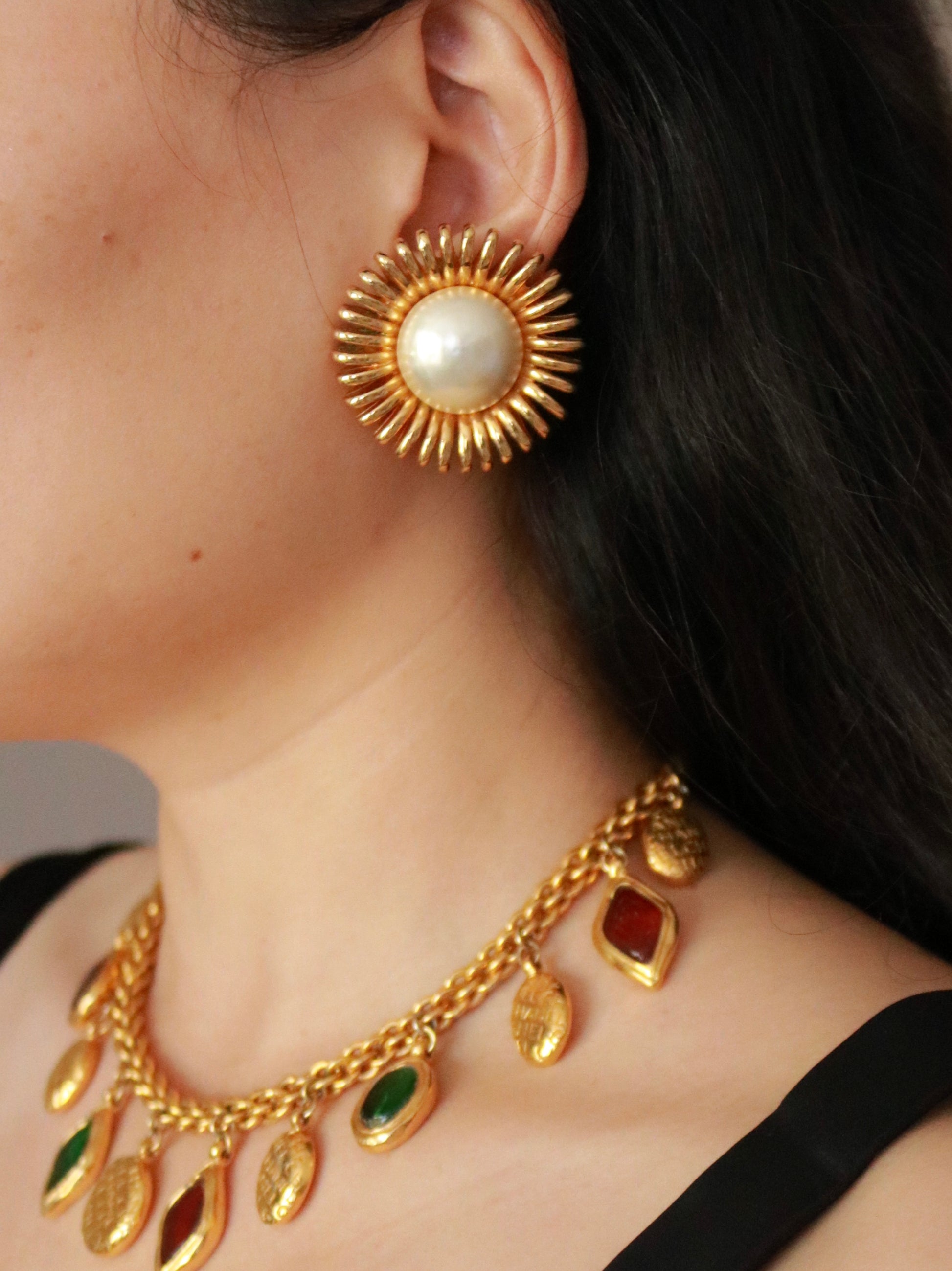 Authentic vintage Chanel daisy clip-on earrings by Karl Lagerfeld worn on model, showcasing iconic 1980s Chanel design.