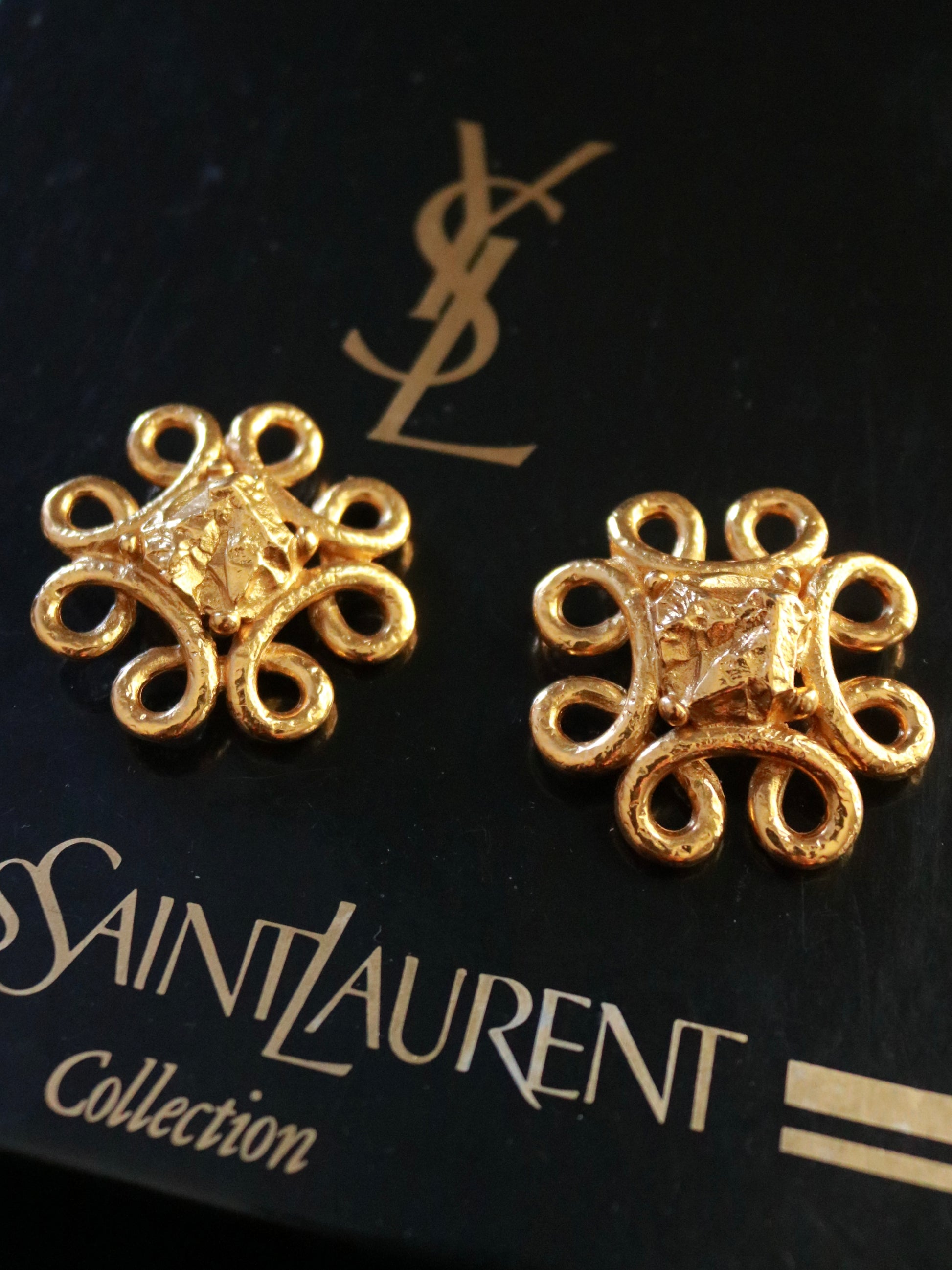 Authentic Yves Saint Laurent lava gold clip-on earrings, 1990s, featuring a sculptural floral-inspired design in textured gold-tone metal.