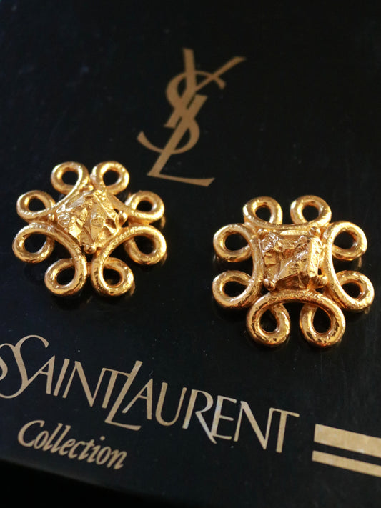 Authentic Yves Saint Laurent lava gold clip-on earrings, 1990s, featuring a sculptural floral-inspired design in textured gold-tone metal.