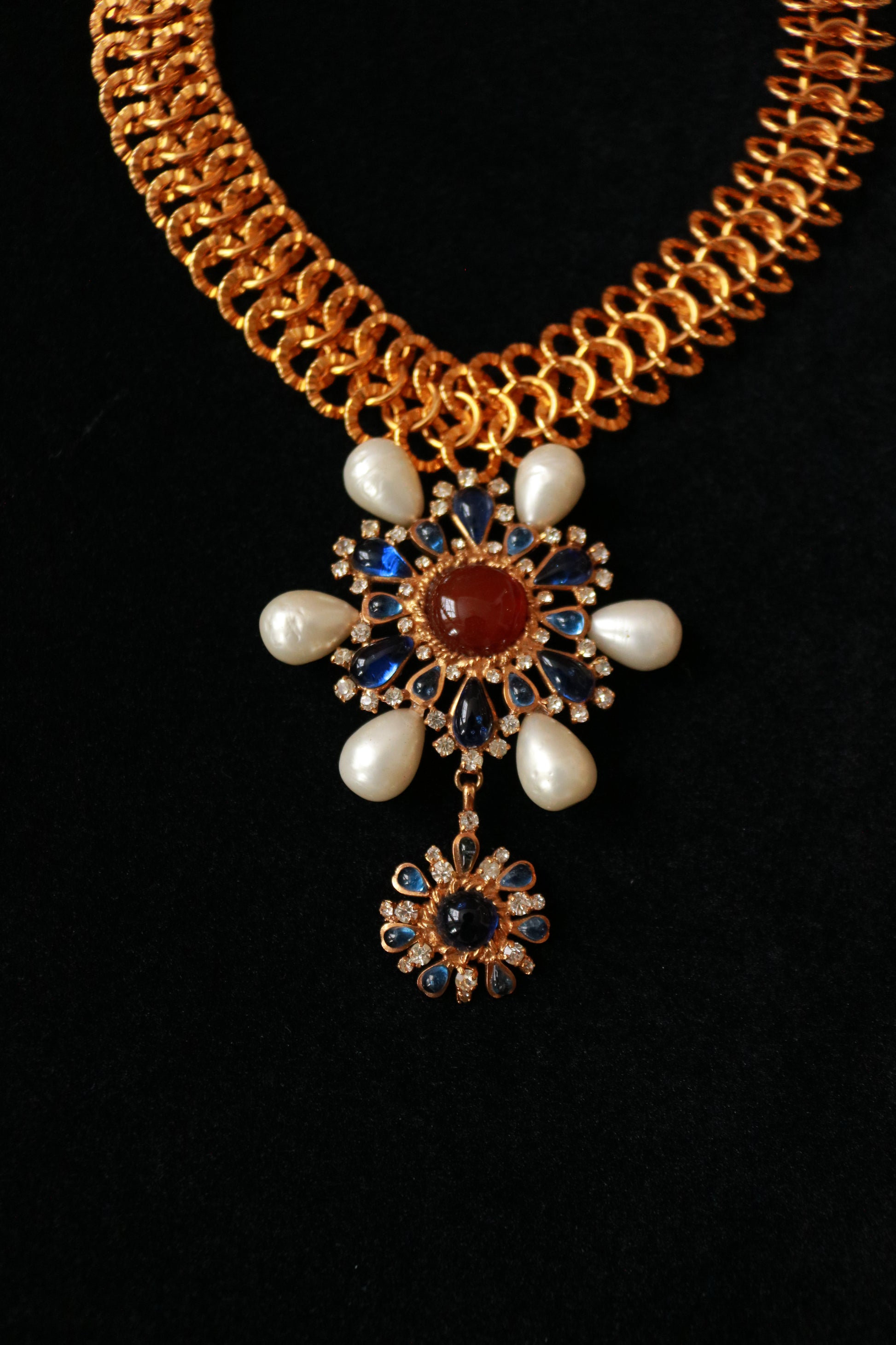 Authentic Chanel vintage necklace worn as a statement piece, featuring detachable pendant and faux pearls.